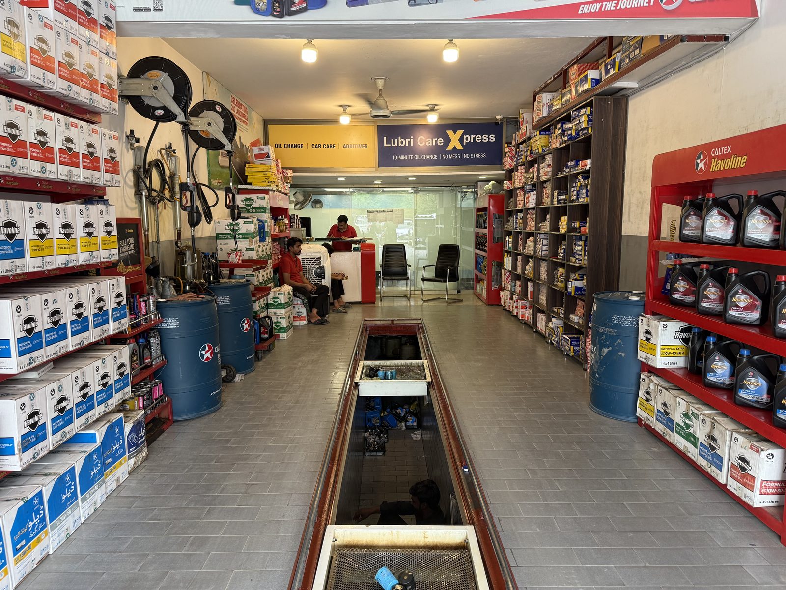 Shelves of genuine Caltex Havoline motor oil stocked at Lubri Care Xpress